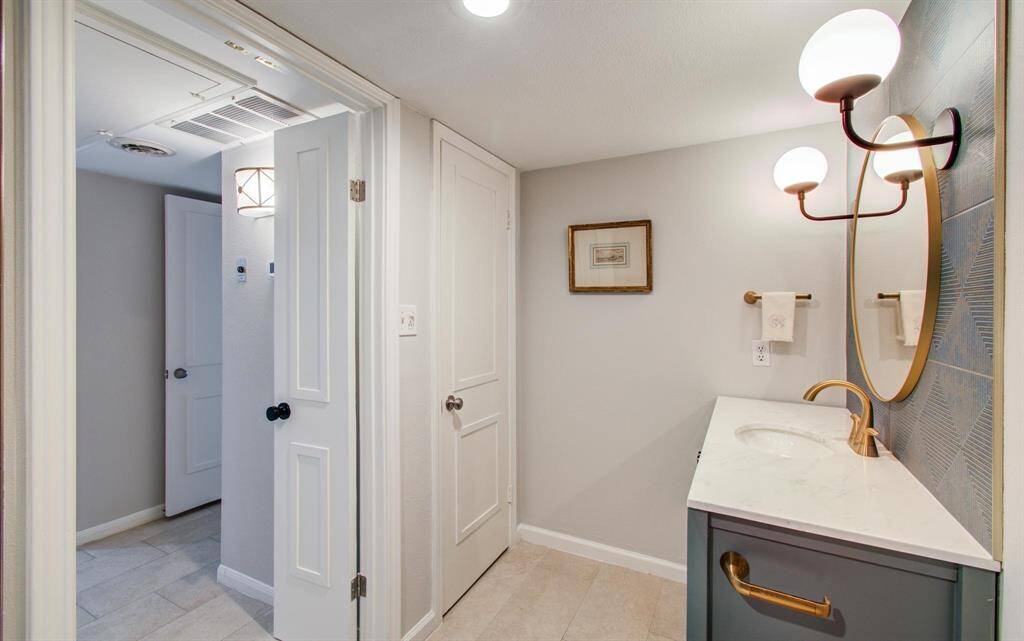 This well-planned bath also includes a full-sized storage closet!