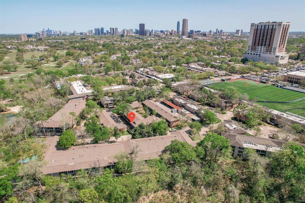 Gorgeous bird's eye view of the condo, nestled among mature trees and well-tended landscaping.  The sparkling pool is just steps away!
