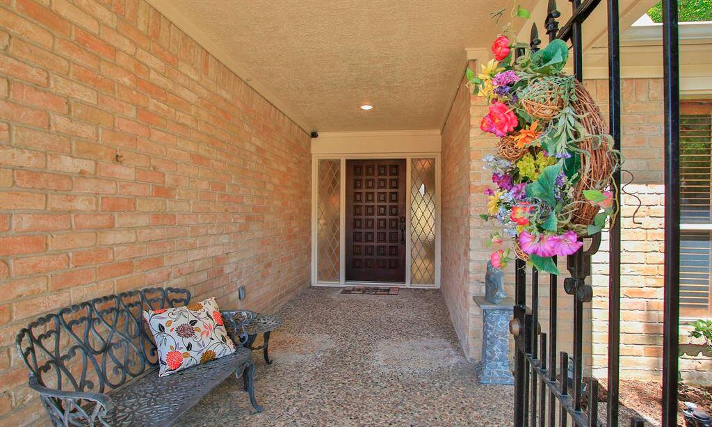 ENTER THRU THE PRIVACY GATE... TO THE COVERED PORCH/WALKWAY .. FOR THE FABULOUS ONE STORY THAT WAITS INSIDE...