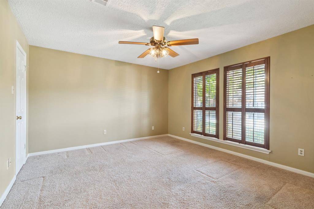 BACK TO THE FRONT BEDROOM.. SHUTTERS PROVIDE VIEW OF FRONT GARDENS...GREAT FOR AN IN-HOME OFFICE..
