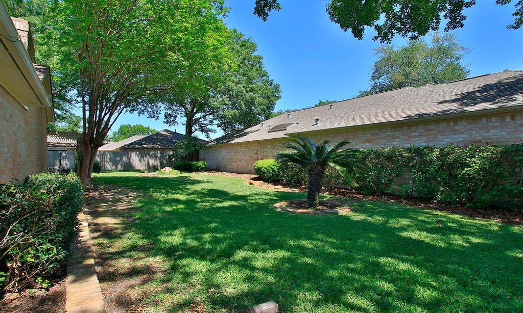 VIEW FROM THE FRONT YARD...DOWN THE SIDE...LOVELY YARD SPACE ...