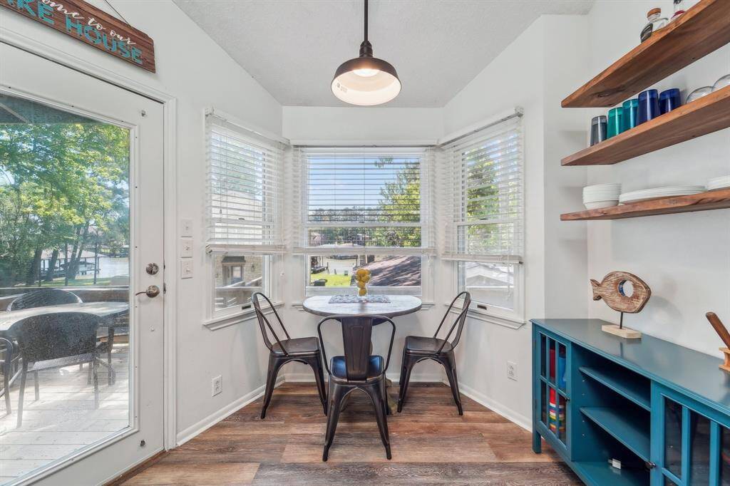 The charming breakfast nook offers a comfortable spot to enjoy morning coffee or casual meals, surrounded by natural light and views of the backyard