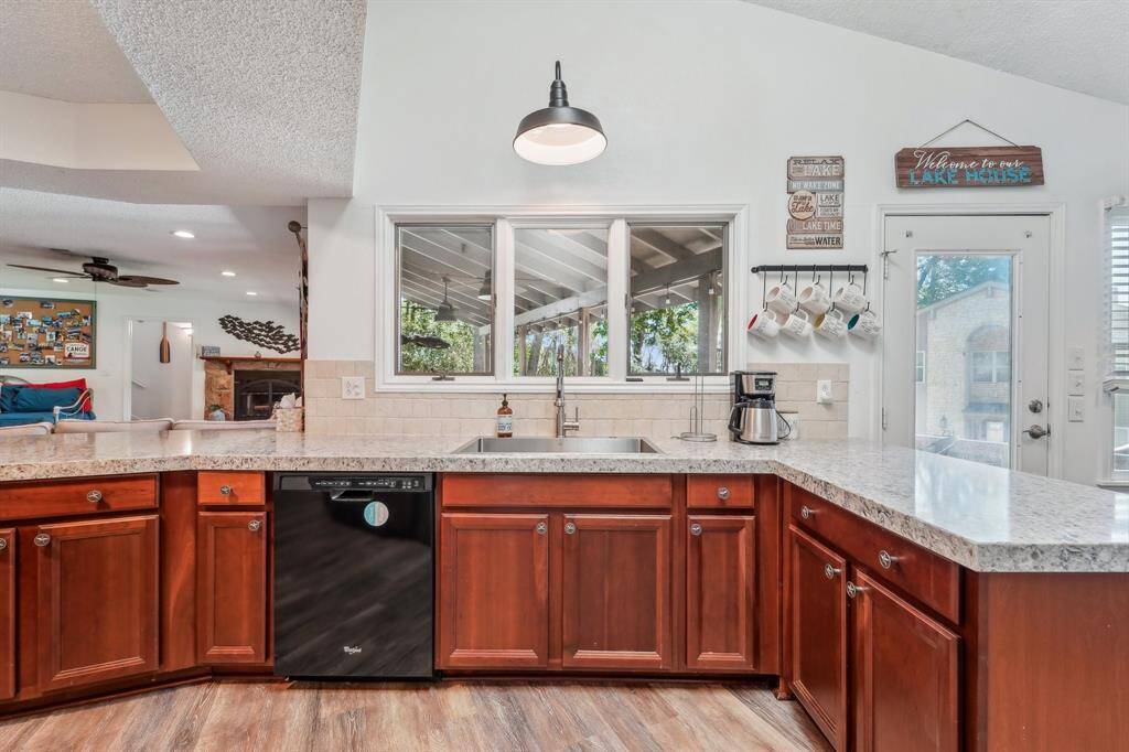The large, spacious kitchen showcases granite countertops, a classic farmhouse sink, and abundant cabinetry—combining style and function for the heart of the home
