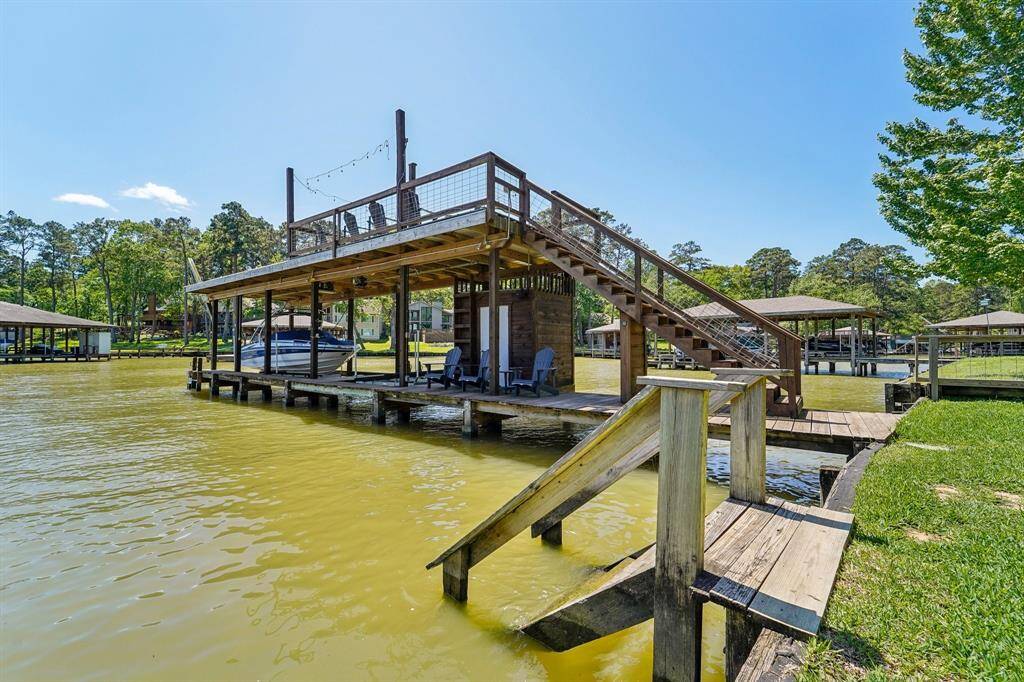 This impressive two-story boat dock offers both functionality and charm. The lower level provides ample space for mooring your boat.