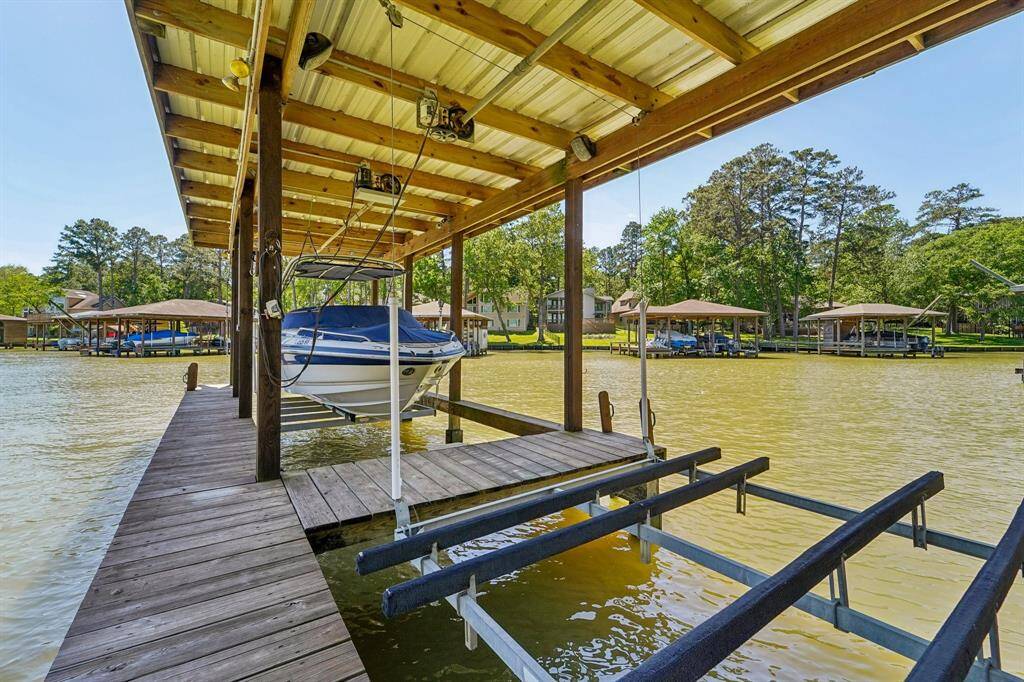 The dock is equipped with an electronic boat slip for easy, hassle-free docking, along with two jet ski lifts for quick and convenient access to the water. Whether you're boating or enjoying water sports, this dock is designed to meet all your lakefront needs. Storage closet for all the lake toys as well.