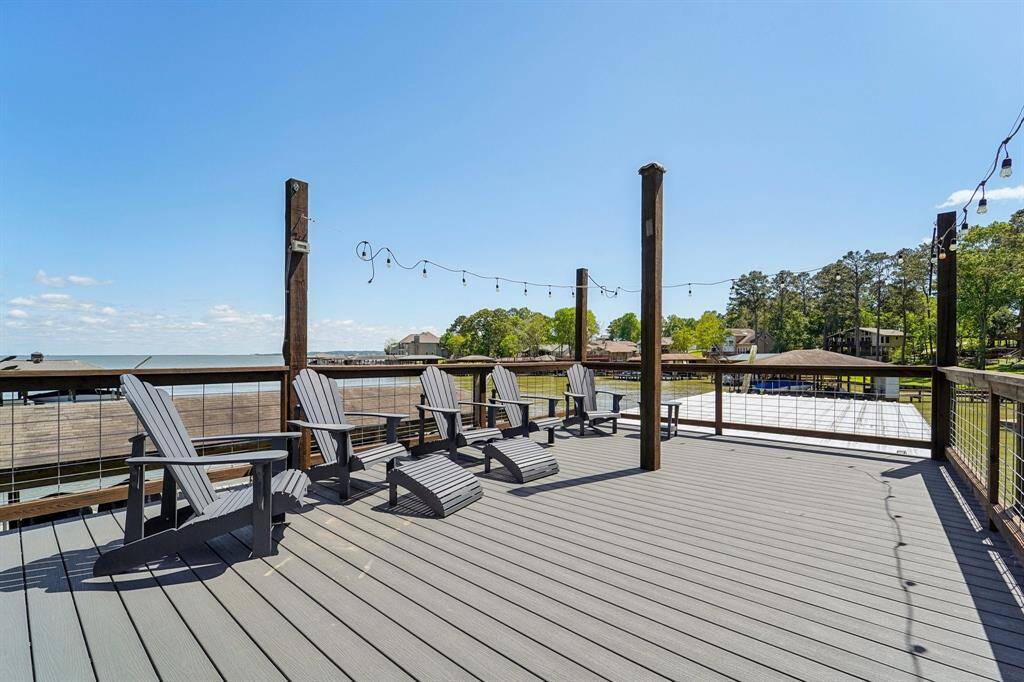 The upper deck is perfect for relaxing, fishing, or entertaining guests with stunning lake views. Featuring durable wooden beams and a sturdy railing, this dock seamlessly blends rustic appeal with modern convenience, making it an ideal waterfront retreat