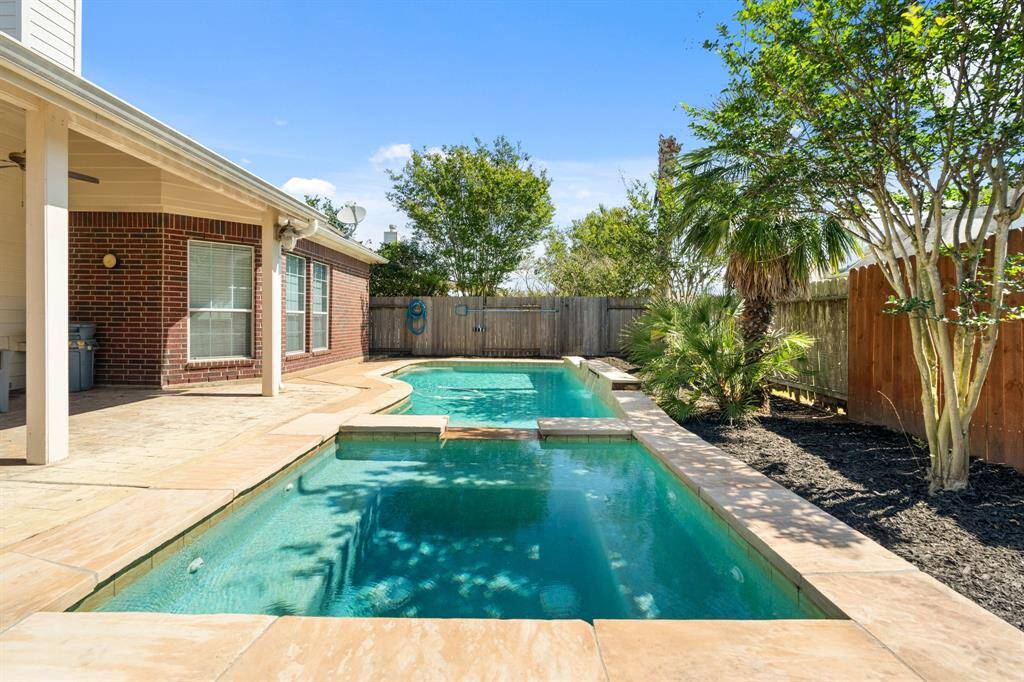 The in ground pool is complete with a jetted spa making it the perfect outdoor space in any season! The large covered patio gives perfect views of the pool and is complete with out door ceiling fans.