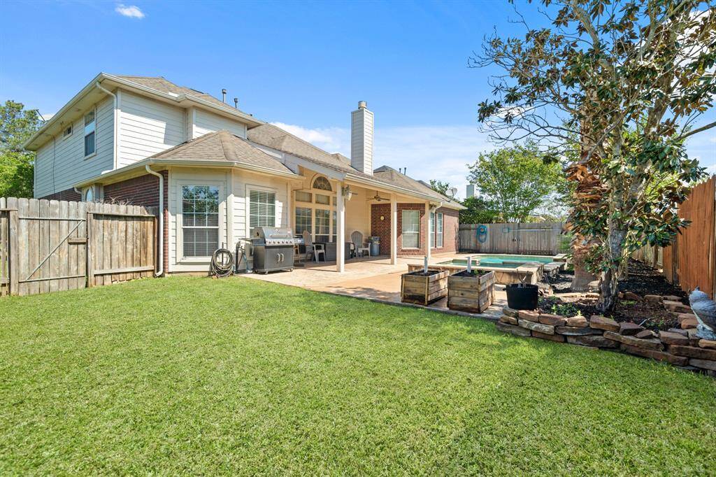 There's still plenty of green space to enjoy in this spacious backyard! This covered patio is perfect for relaxing or entertaining year-round. Just add good company and enjoy!