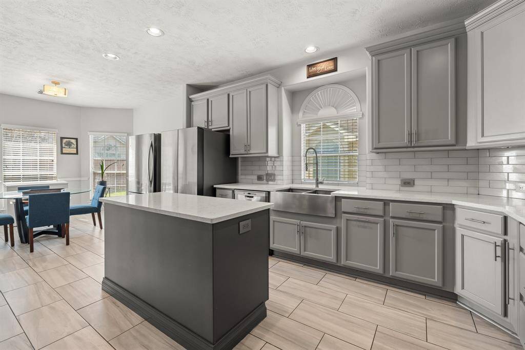 Step inside the heart of the home and see the beautifully remodeled kitchen! This open kitchen features elegant cabinetry, quartz countertops, sleek stainless steel appliances, and stylish modern backsplash—perfect for gathering and entertaining.