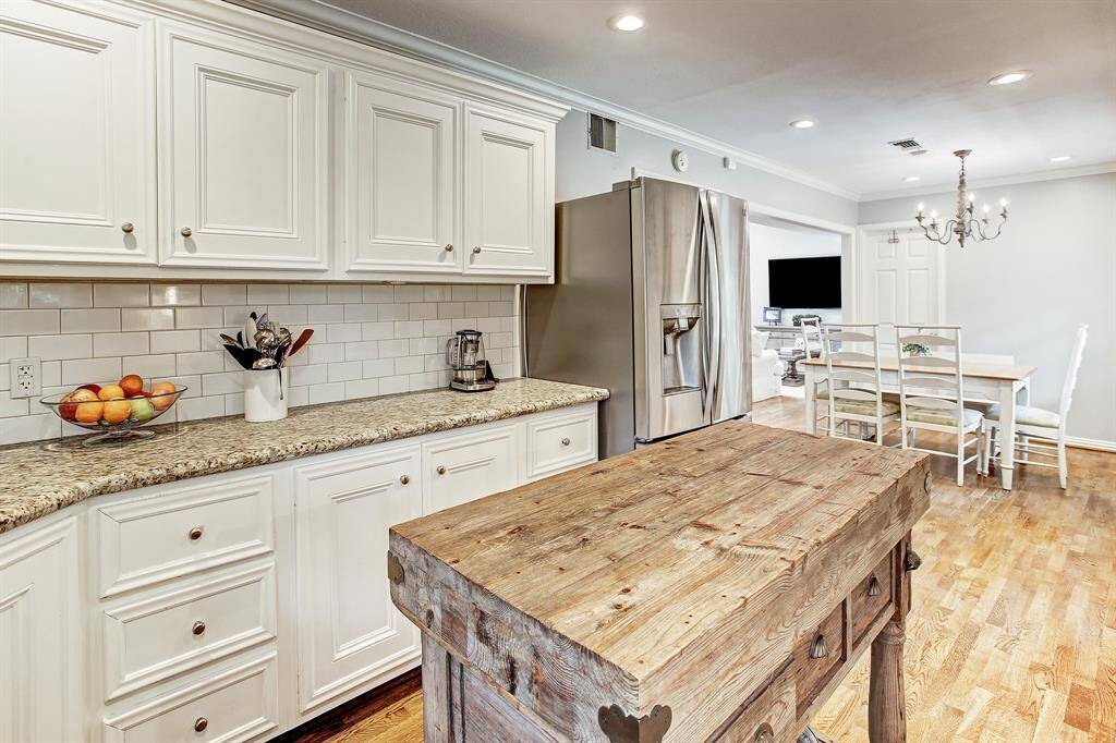 Another view of the kitchen showing the refrigerator and opening into the breakfast room.