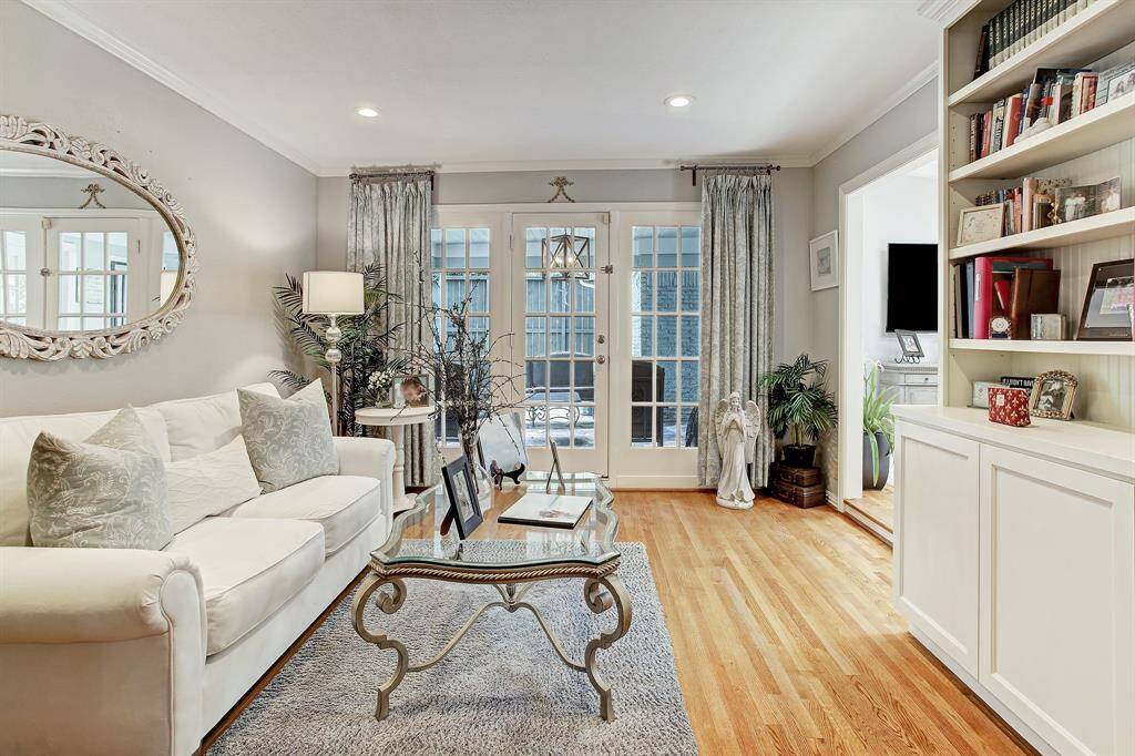 This lovely formal living room is just inside the foyer. Hardwood floors run throughout the entire home. The French door opens onto the patio.