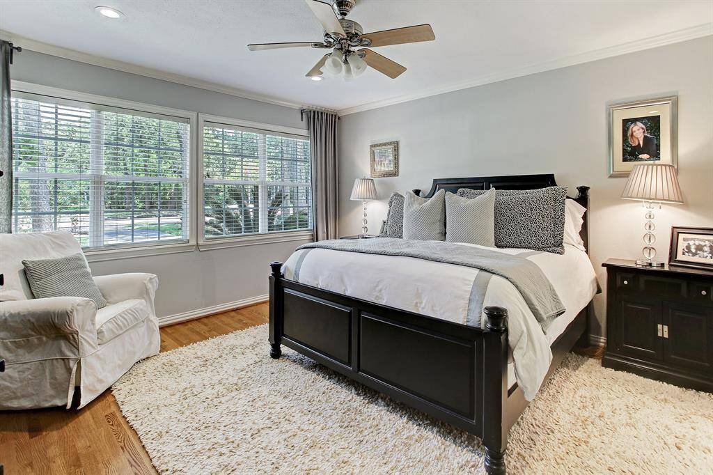 The master bedroom is on the first floor. Crown molding, hardwood floors, designer paint and window treatments enhance the home.