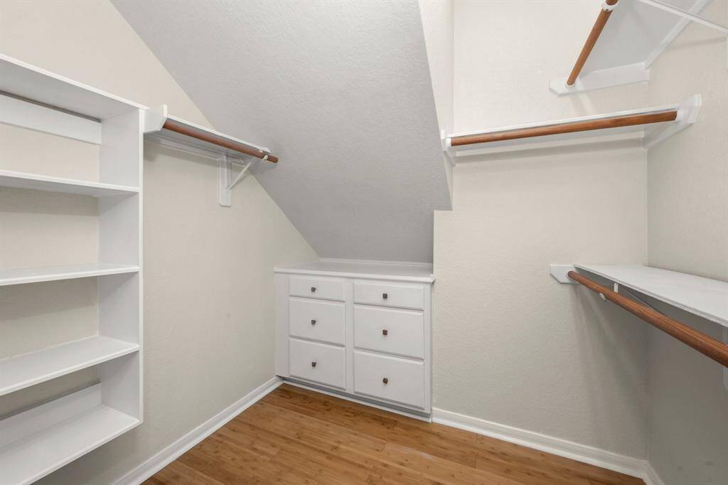 Primary bedroom closet with built-ins-ns