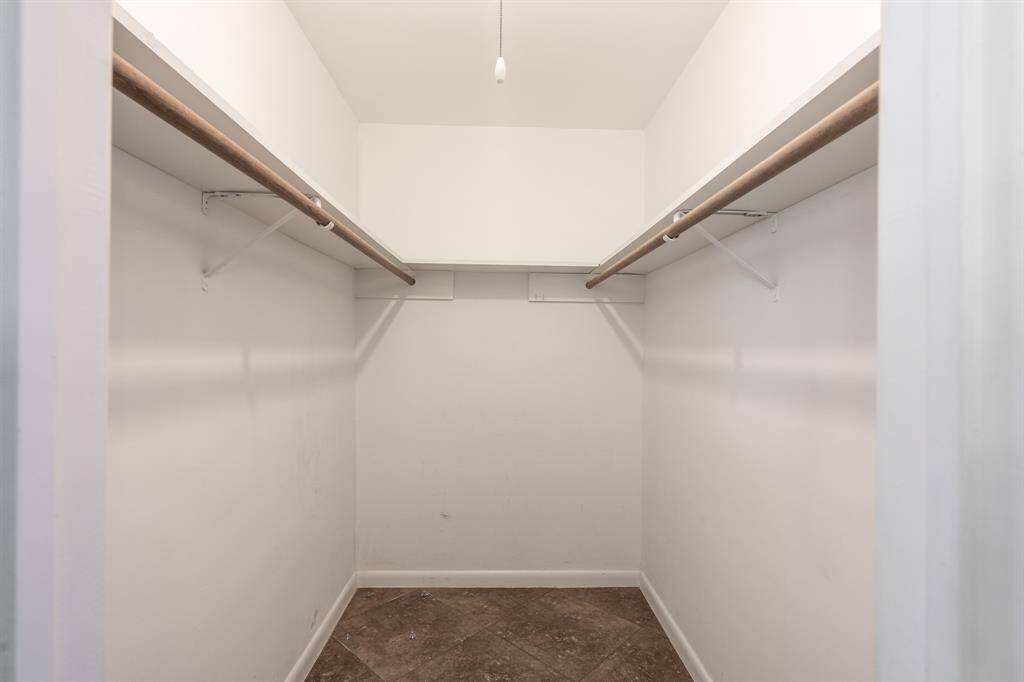 Walk in closet in primary bedroom.