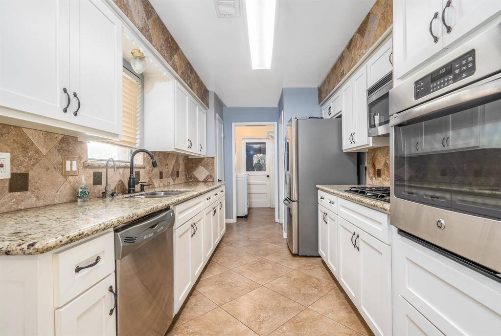 Galley kitchen has lots of counterspace and storage.