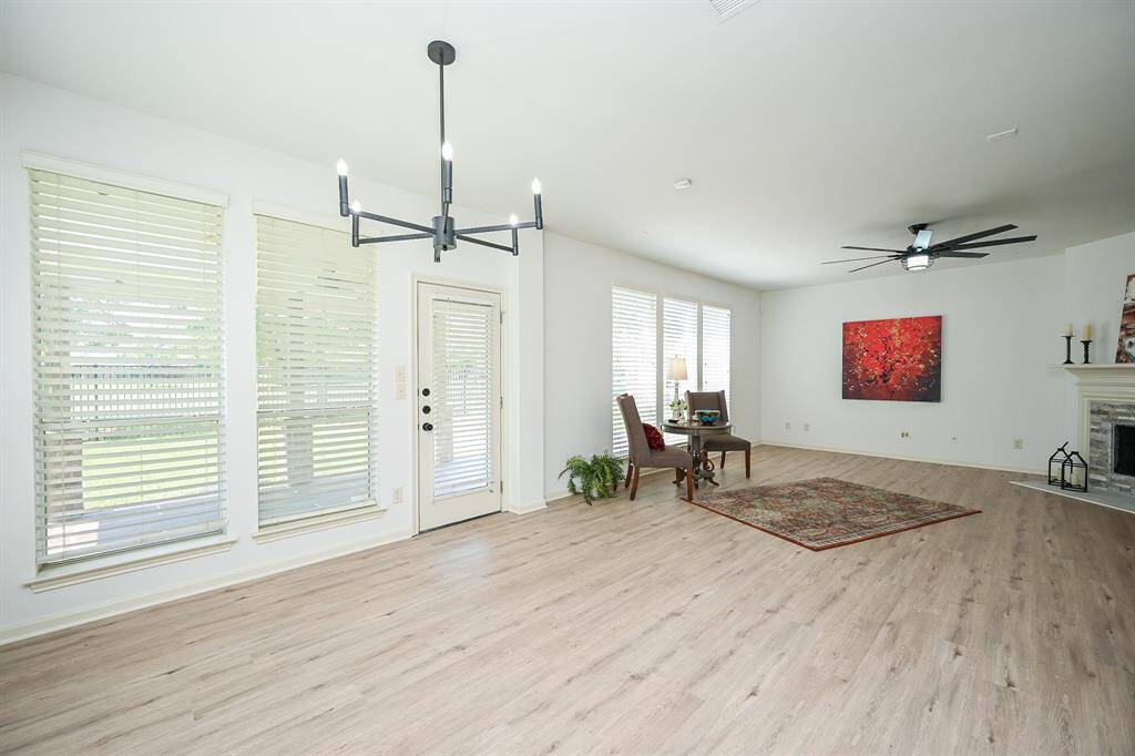 The breakfast room features a chandelier and windows with views in your backyardnext to the back door.