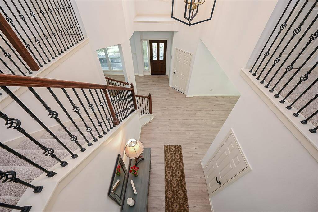The chandelier lights up the entryway from above.