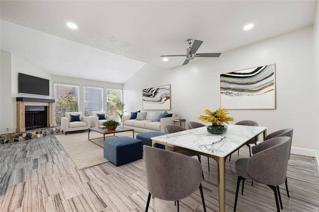 Open concept living room and dining room that faces the fireplace.