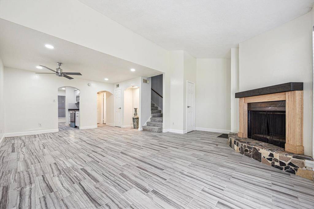 Spacious living room seamlessly flows into the dining area, conveniently next to the kitchen for effortless entertaining.