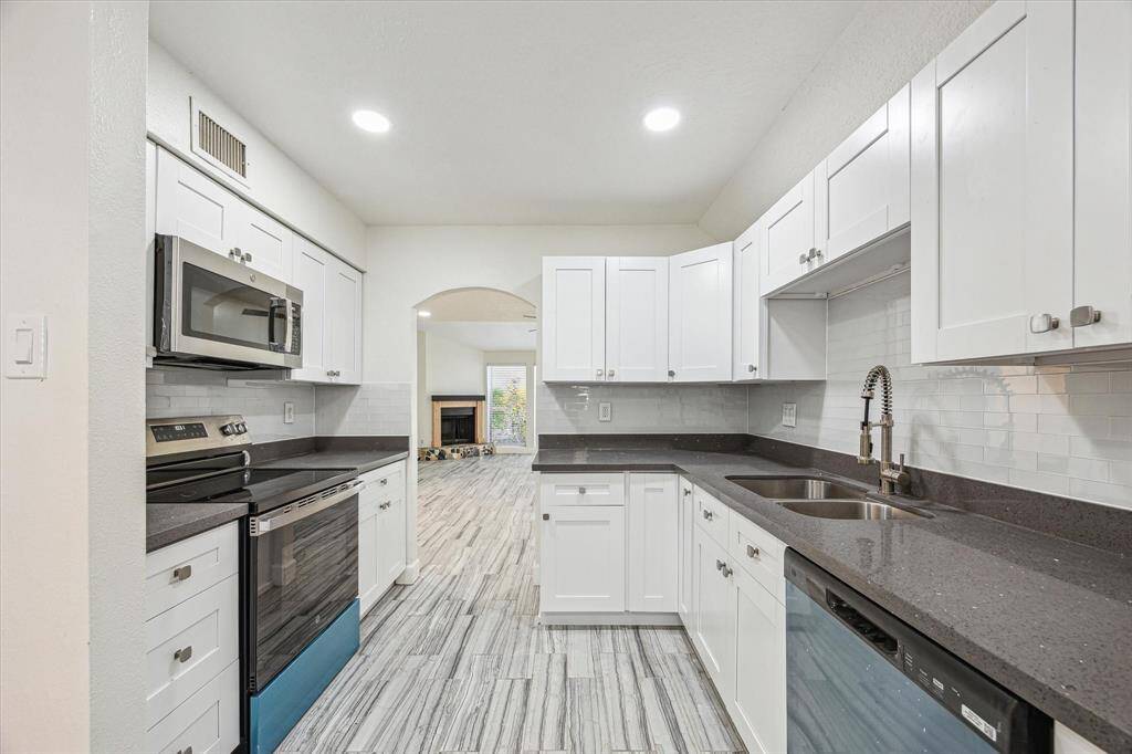 Sleek kitchen with durable quartz countertops and stylish recessed lighting.
