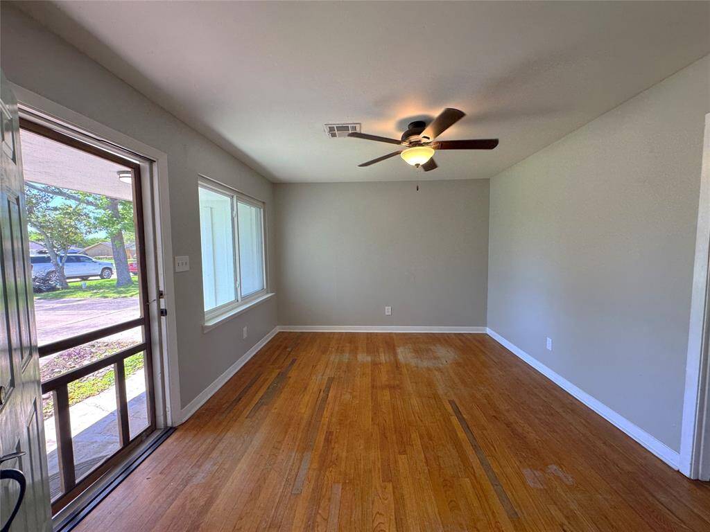 Large living room has screened door to let in the light and breeze