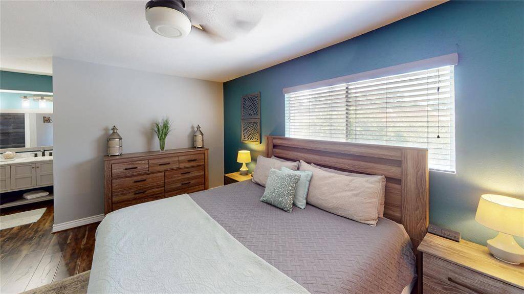 Primary bedroom with large window with a lot of natural light.