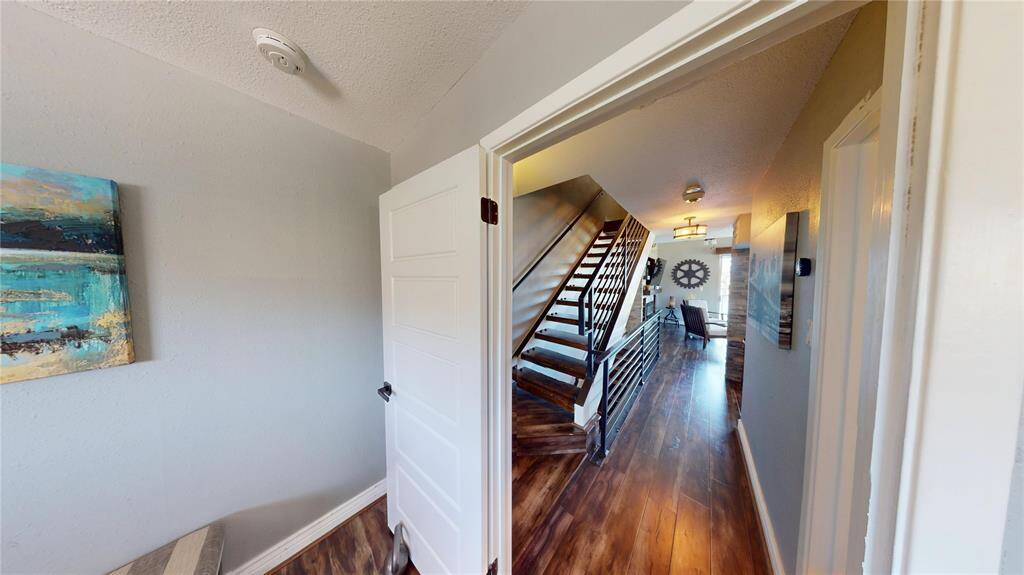 Looking from the primary into the main living area, and staircase