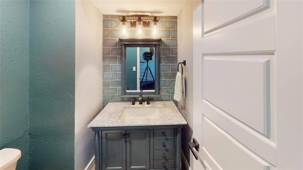 Guest 1/2 bath located on the main living floor just before entering the primary outside the kitchen