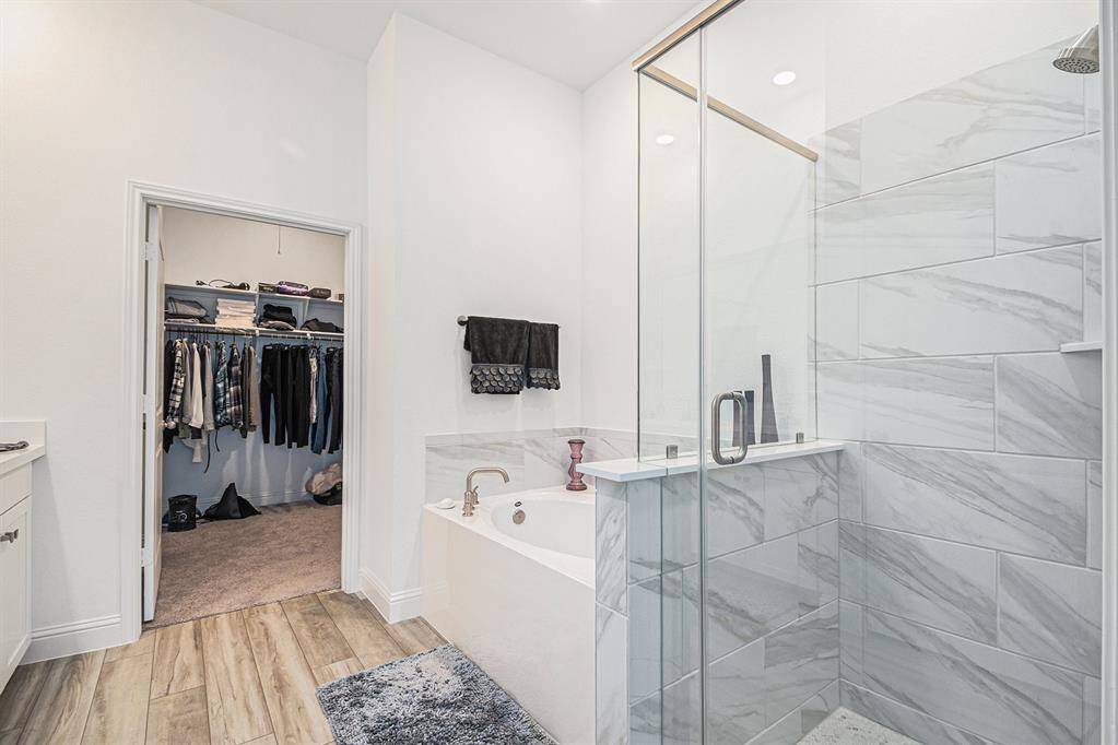 Primary bathroom features 2 sinks and soaking tub w/separate shower