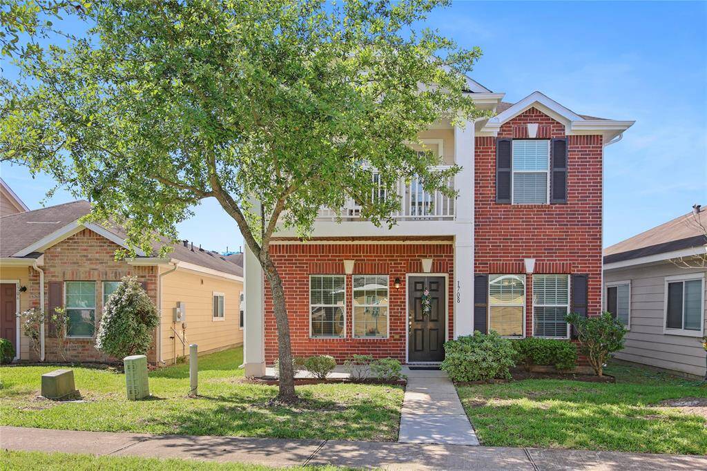 Elegant two-story home with a lovely balcony, perfect for relaxation.