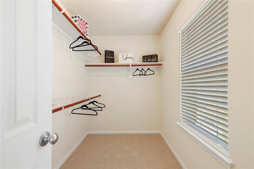 Spacious walk-in closet in the primary bedroom, offering ample storage and natural light.