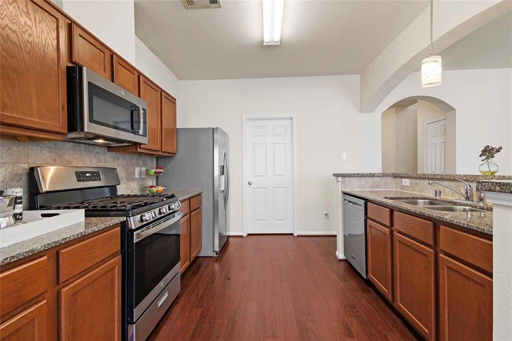 Contemporary kitchen with an island sink and convenient adjacent laundry room.