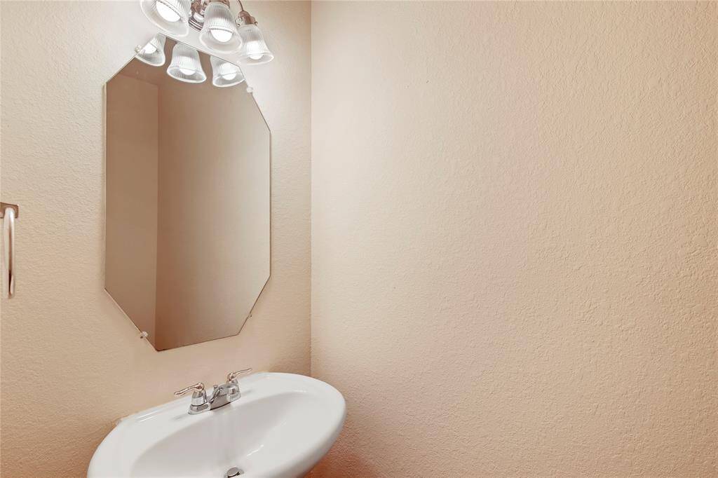 Sleek guest bath with elegant pedestal sink and stylish fixtures.