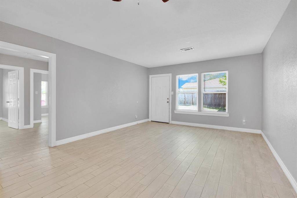 Spacious and bright living/dining area with fresh neutral tones and abundant natural light. Perfect for entertaining and relaxation.