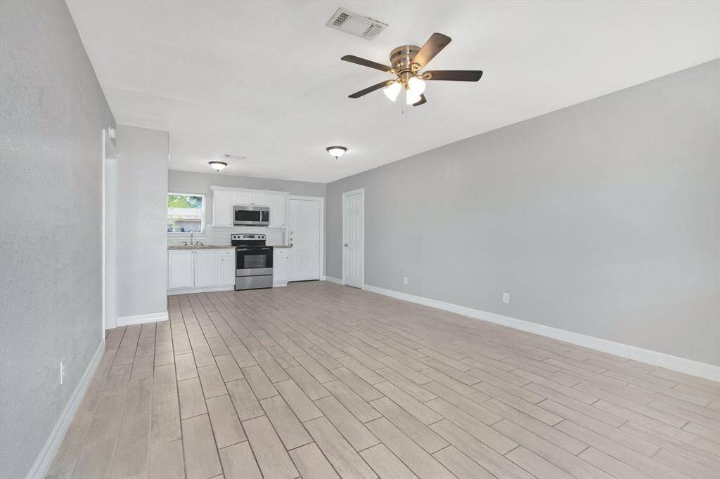 Welcome to a bright and spacious living area, seamlessly connected to the kitchen for effortless entertaining.