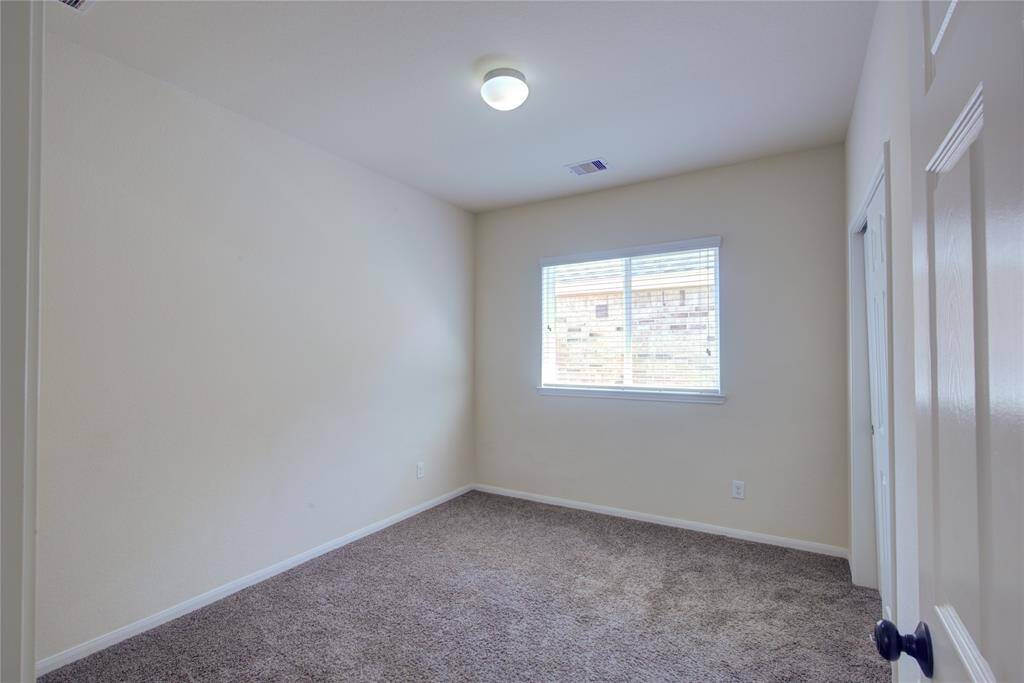 spacious bedroom with ceiling light