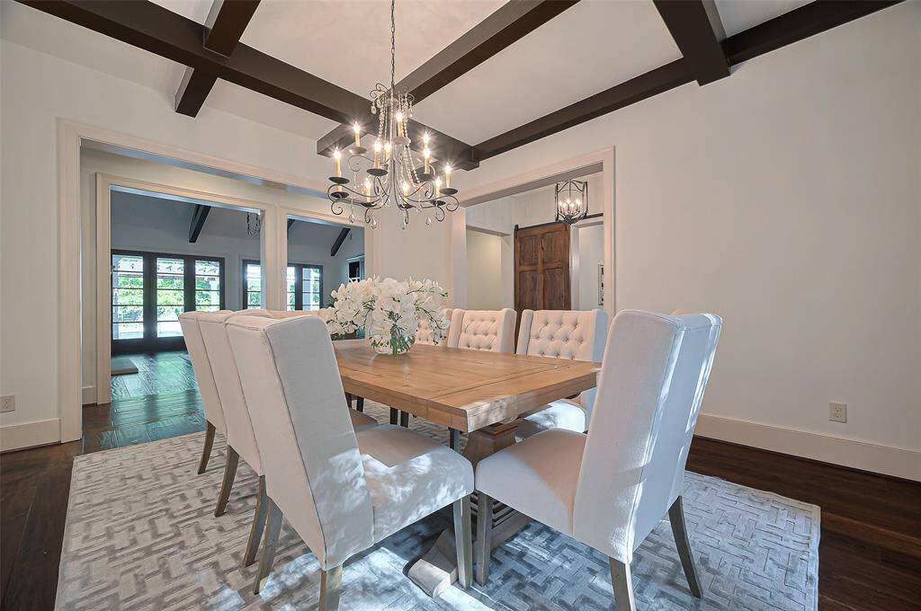 Entertain in this dining room, show cases area for your largest of dining tables. The space is highlighted by exposed beam ceilings and large windows that offer plenty of natural light. A cozy, open layout leads into a bright living area.