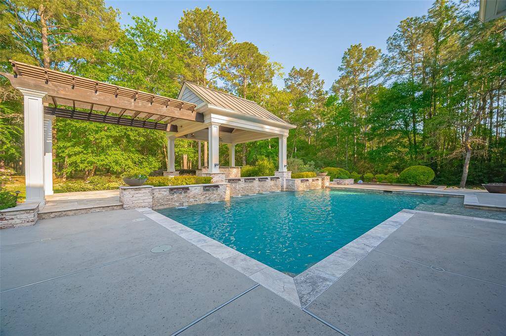 Feel like every day is a vacation! This oasis of a pool is surrounded by lush greenery for privacy. It includes a covered pergola, perfect for relaxation and entertaining.