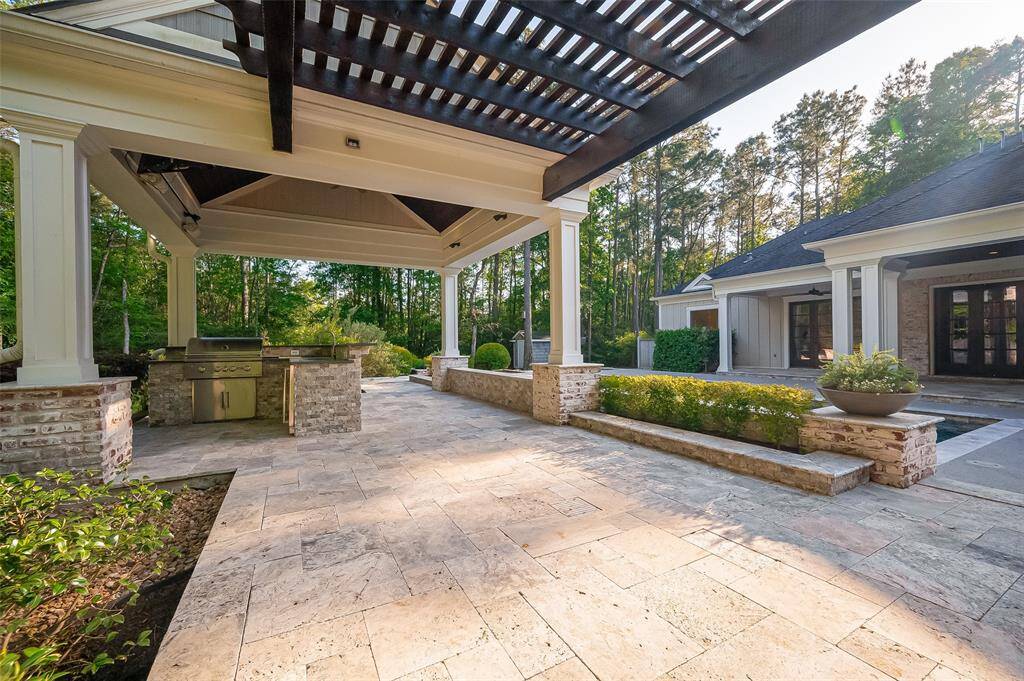Anyone say cookout??? Outdoor Kitchen, patio area, covered pergola, built-in grill, and stone flooring.