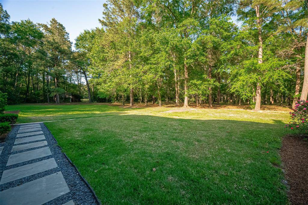 10 GORGEOUS PRIVATE FULLY FENCES ACRES! BRING THE HORSES. Lush lawn, bordered by mature trees, with a stone pathway is perfect for enjoying outdoor activities.