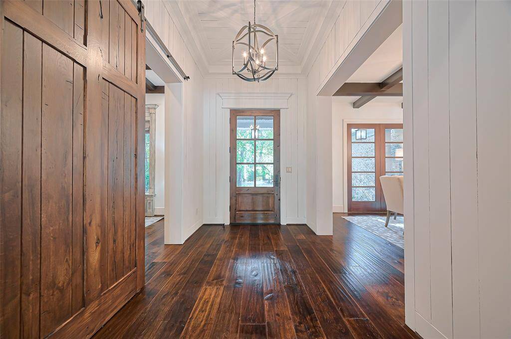 Greet your family and friends in this lovely entryway with beautiful wood floors, elegant lighting and fresh modern paint colors throughout the entire home.