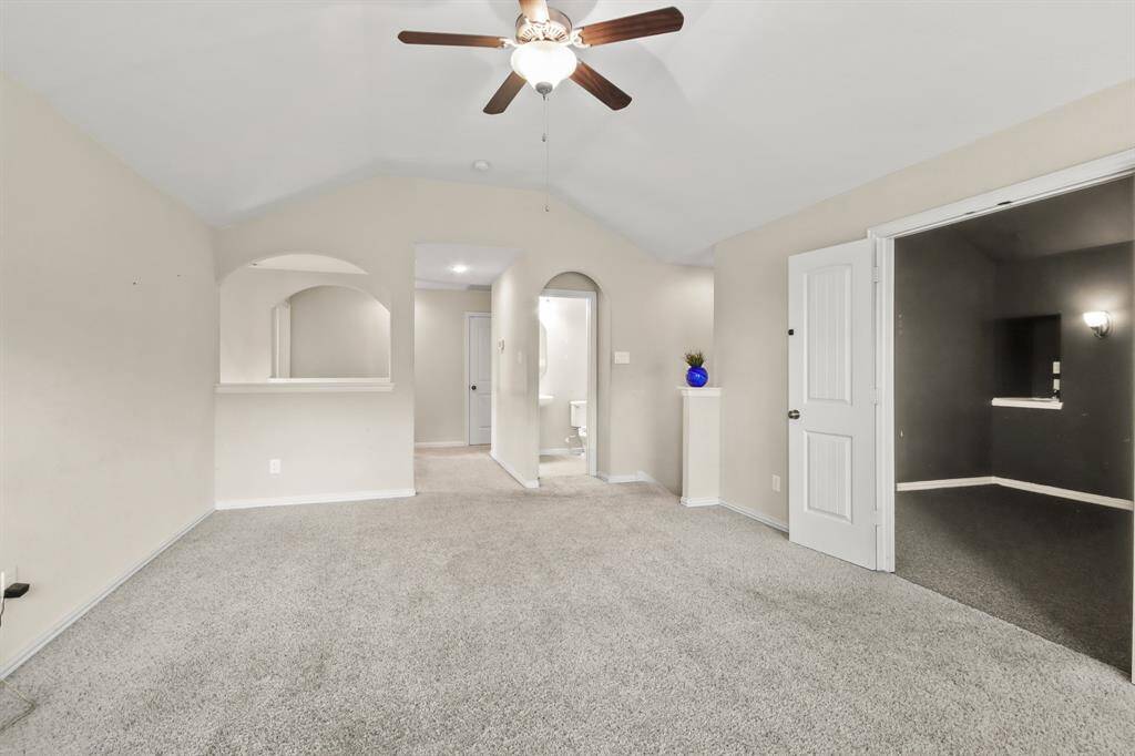 Spacious game room with high ceilings, connected to a separate media room for added entertainment space.