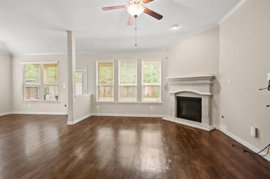Spacious living room with a cozy gas fireplace and an open floor plan.