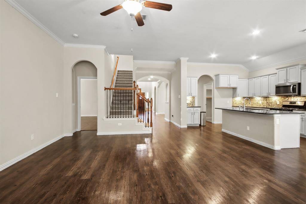 Spacious living room with a cozy gas fireplace and an open floor plan.