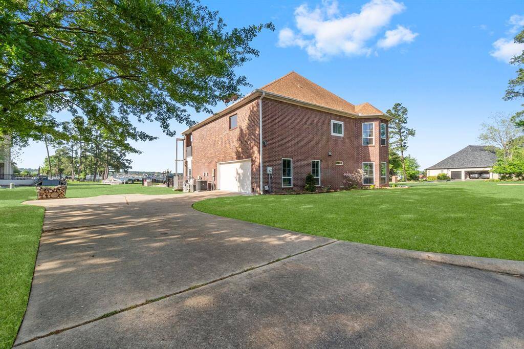 This photo showcases a home with an elevator for easy access to the 2nd floor, overlooking a spacious, well-maintained yard.