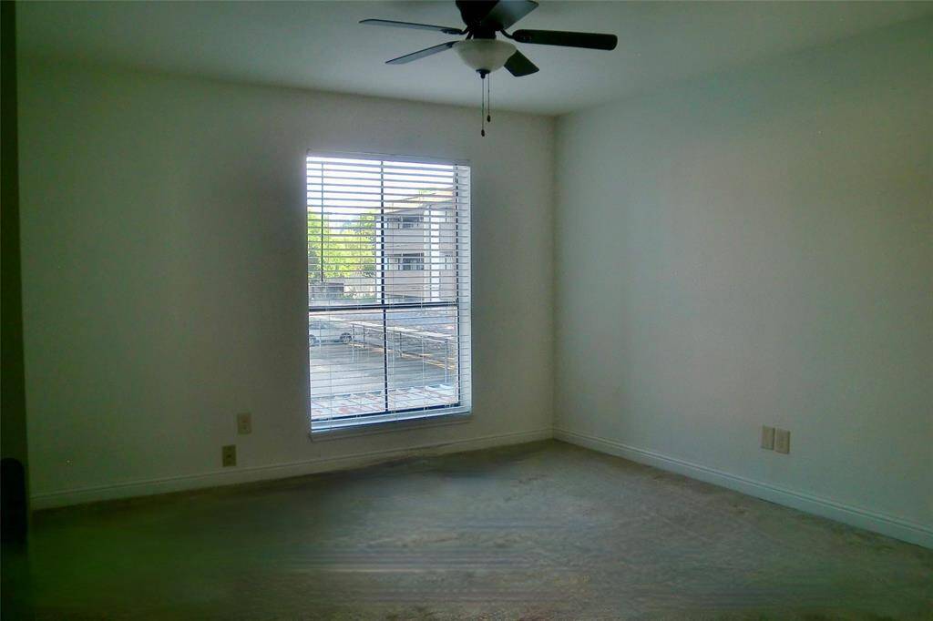Experience comfort in this serene master bedroom featuring ample natural light and a stylish ceiling fan. Perfect for relaxation and rest.