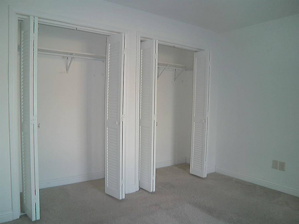 Spacious second bedroom with ample closet space and natural light.