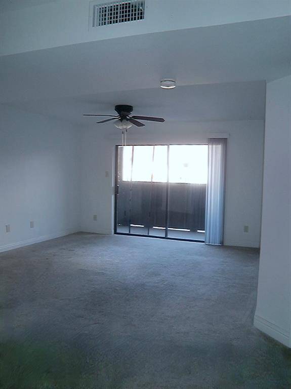 Bright living area leading to a cozy balcony.