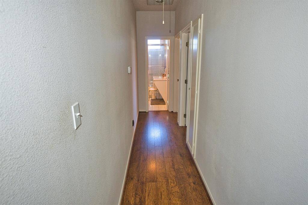 Hallway between the Primary Bedroom & other bedrooms. Main Bath on the end