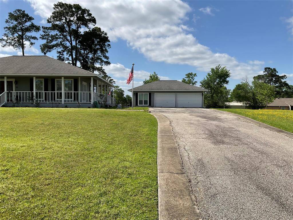 Really long driveway with three cars across at he top.